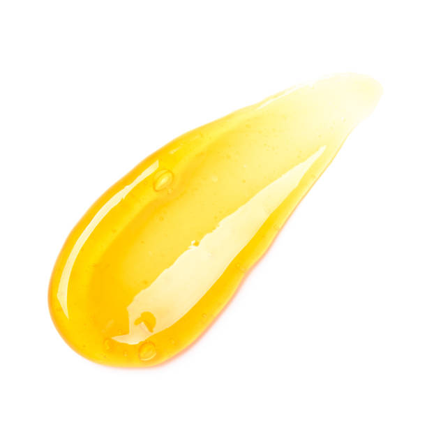 istock Clear orange gel smear with bubbles isolated on white background 1406697790