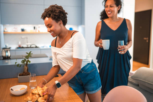 istock Cute Hispanic Mother And Daughter Having Breakfast On The Weekend 1406697991