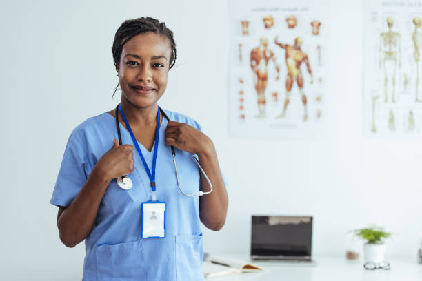 istock Confident young female doctor in blue uniform standing in office 1406698246
