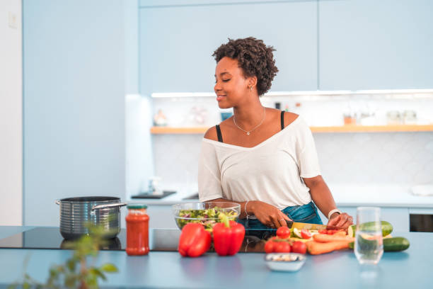 istock Young Hispanic Female Cooking In The Kitchen 1406698961