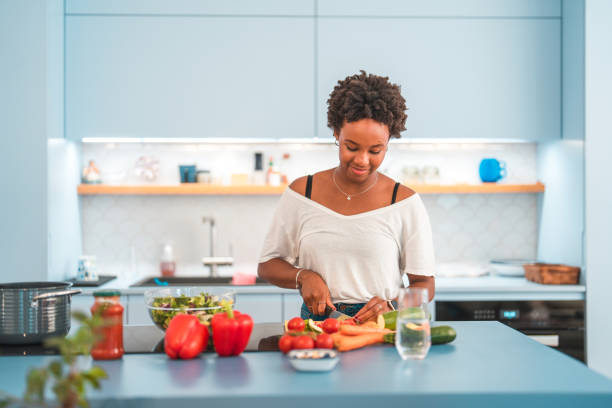 istock Young Hispanic Female Cooking In The Kitchen 1406699036
