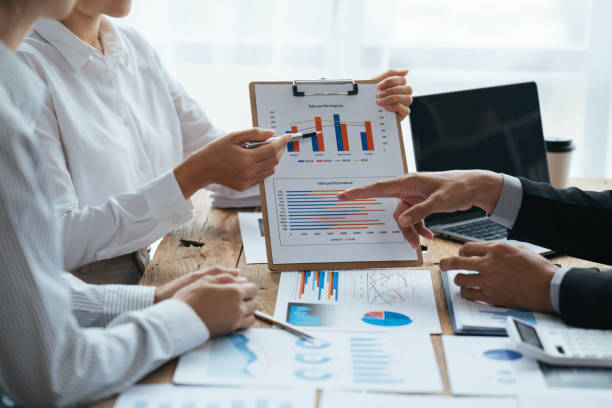 istock Business people working in the office discussing documents and ideas at meeting, Asian business advisor meeting to analyze and discuss the situation on the financial report. 1406699281