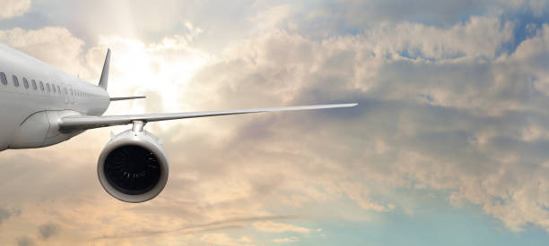 istock White empty commercial business airplane against blue sky and white cloud background. Transportation and travel concept 1406699464