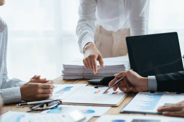 istock Business people working in the office discussing documents and ideas at meeting, Asian business advisor meeting to analyze and discuss the situation on the financial report. 1406700014