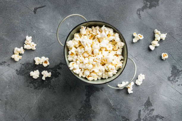 istock Olive oil popped popcorn  on gray stone table background, top view flat lay, with copy space for text 1406701533