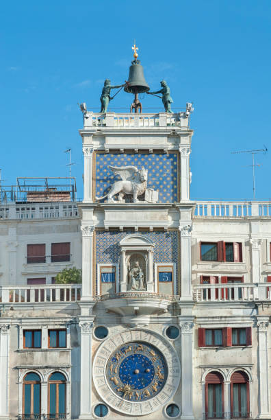 istock Zodiac clock. Clock Tower with winged lion and two moors striking the bell - early Renaissance (1497) building in Venice, located the north side of Piazza San Marco, Italy, Europe. 1406701675