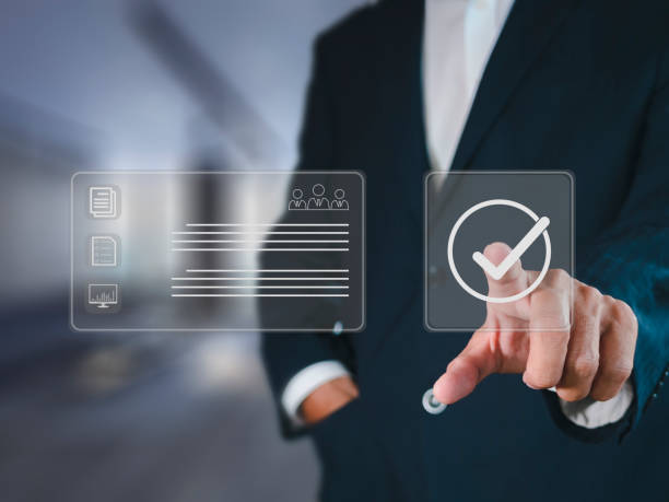 istock Businessman hand point check mark on virtual screen for quality control QC certification assures that the company product satisfies specifications. 1406702486