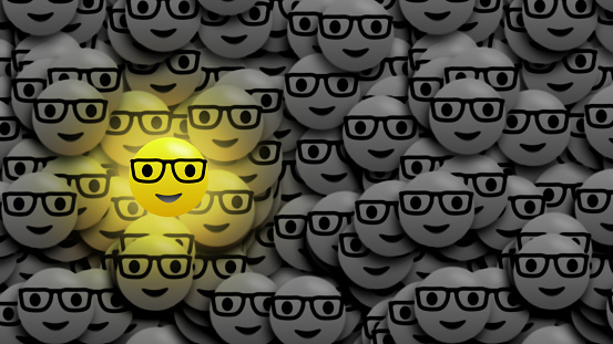 bright gold light isolated on black and white dark blur emoji.  Social media expression and emotions concept.