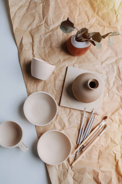 istock Composition of ceramic vessels, pottery tools on a wrapping paper. Top view. 1406705577