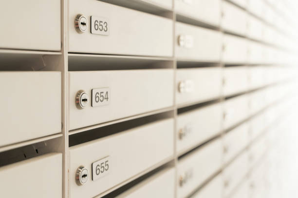 istock Mailboxes for letters and correspondence. Modern white mailboxes with numbers in the lobby of a residential or office building 1406705734