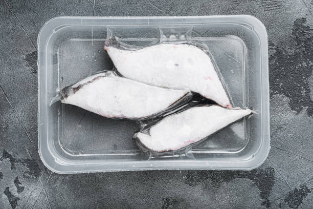 istock Halibut fish frozen steak pack, on gray stone table background, top view flat lay 1406706691