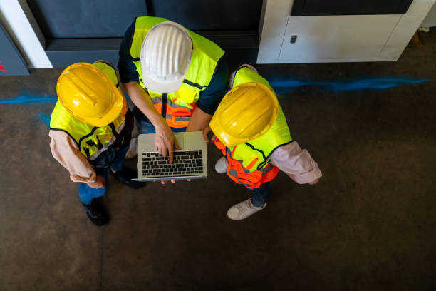 istock Asian man engineer using lap top computer discussion with woman assistant at factory warehouse. 1406706695