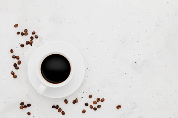 istock Top view on flat lay with single full coffee cup on concrete with roasted beans 1406706763