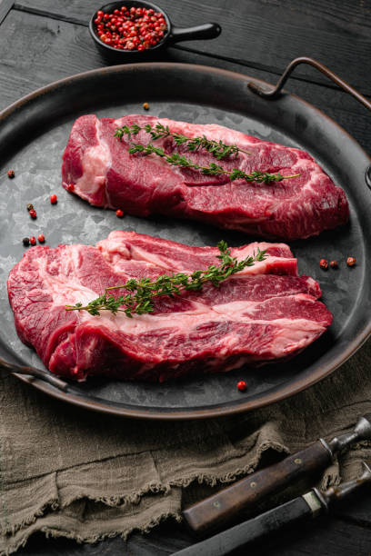 istock Chuck Eye Roll uncooked steak, on black wooden table background 1406706947