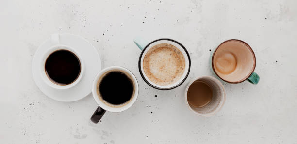 istock Top view on flat lay with many different full and empty coffee cups on concrete 1406707102