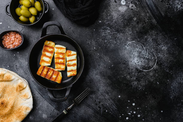 istock Grilling Halloumi Cheese, on black dark stone table background, top view flat lay, with copy space for text 1406707374