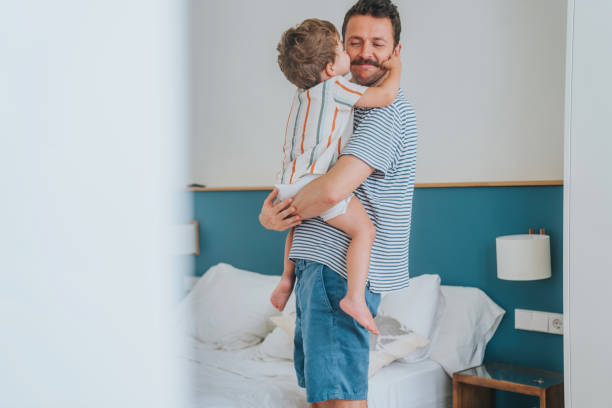 istock Father carrying baby son in bedroom 1406708092