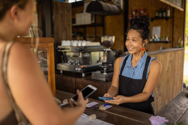 istock Female customer paying with mobile app, at the coffee shop 1406708172