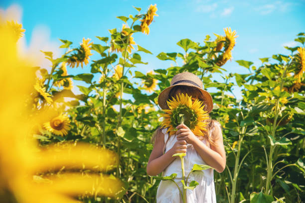 istock Girl With Flower Standing On Field 1406710747
