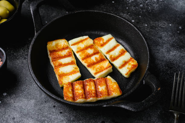istock Grilled Halloumi, fried cheese, on black dark stone table background 1406710866