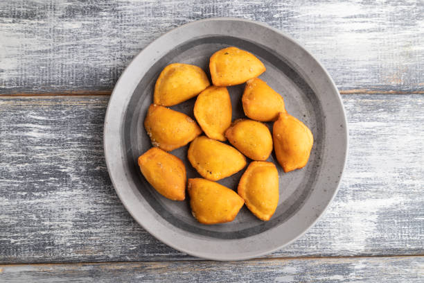 istock fried dumplings on a wooden plate on a gray. Top view. 1406711548