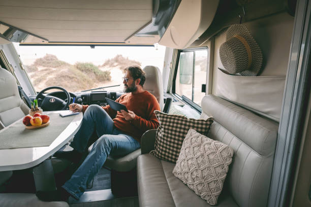 istock Man With Tablet Pc Sitting In Motor Home 1406711915