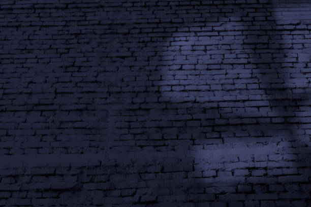 istock Old brick wall with abstract light shape at dark evening time. Blue background image with copy space. 1406712610