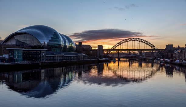The Tyne Bridge at sunset, reflecting in the almost still River Tyne beneath