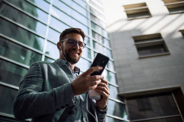 istock Businessman using phone listening music 1406716237