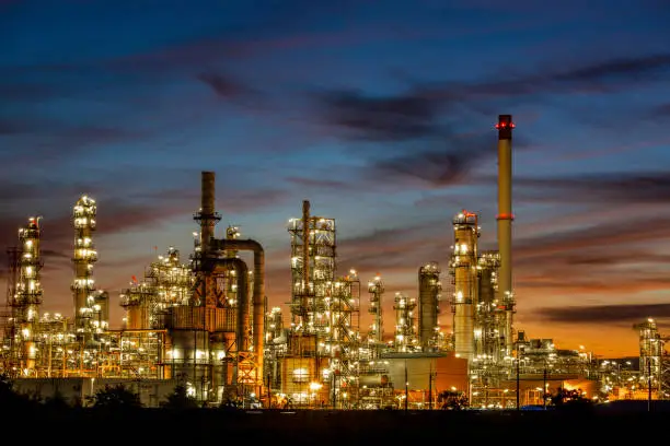 Oil refinery and  plant and tower column of Petrochemistry industry in oil and gas industrial with cloud blue sky the sunrise background