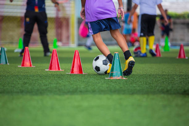 istock Children playing control soccer ball tactics on grass field with for training 1406716260