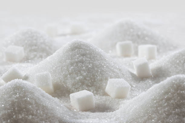 istock White granulated sugar and refined sugar cubes close-up 1406716333