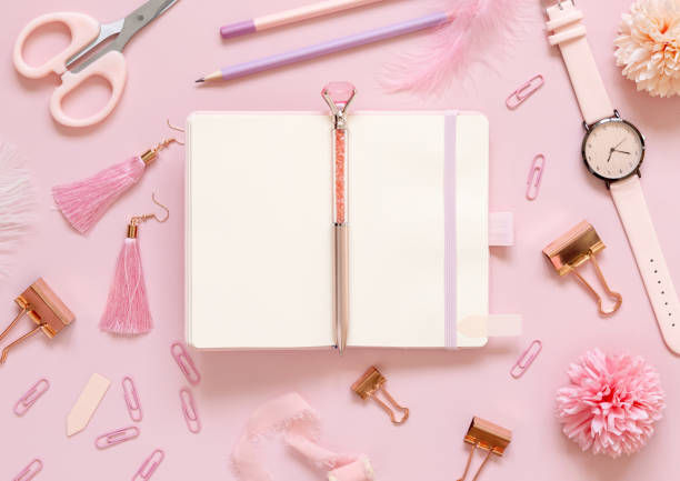 istock Opened notebook and Pink school girly accessories on pastel pink Top view, mockup 1406717300