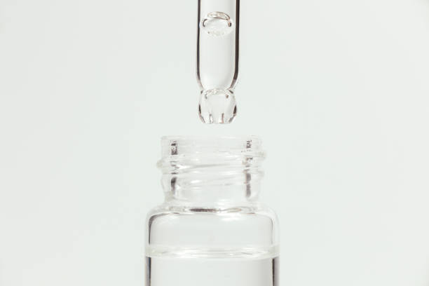 istock Pipette with a glass bottle on a light background. 1406721943