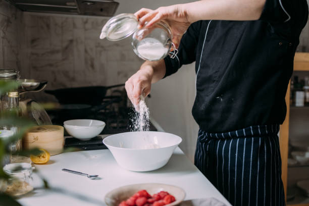 istock Anonymous Caucasian Cook Preparing Dessert, Pouring Flour into a Bowl 1406722931