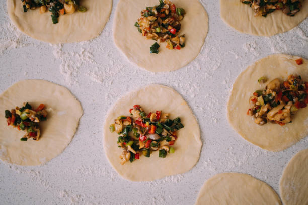 istock Vegetarian Recipes: High Angle Shot of Vegetable Dumplings on a White Surface 1406723005