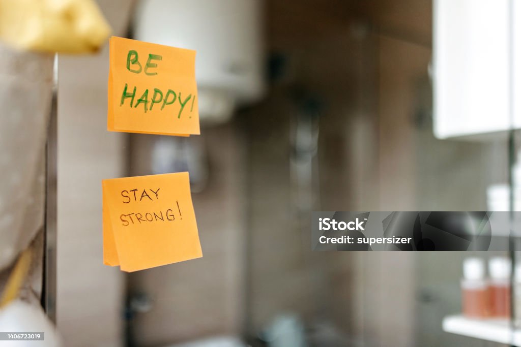 A little morning motivation Supportive messages written on post-it notes, taped to a bathroom mirror. Mirror - Object Stock Photo
