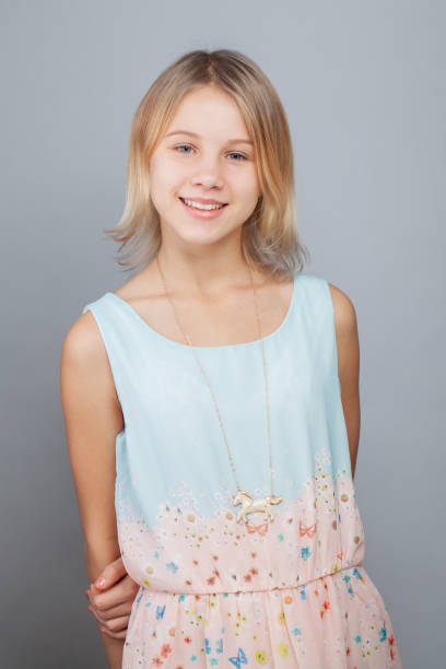 Attractive little girl studio portrait Attractive little girl studio portrait 12 13 years pre adolescent child female blond hair stock pictures, royalty-free photos & images