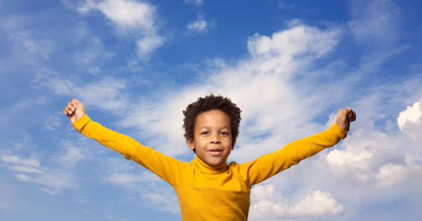 istock Cute happy African American kid boy on sky clouds background 1406723055