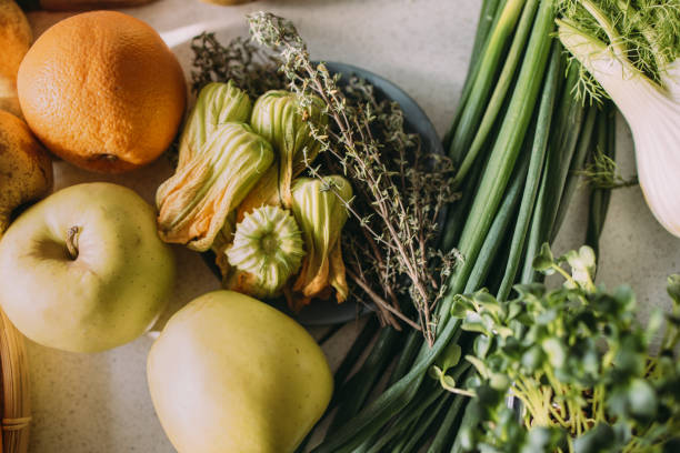 A close up high angle shot of fresh fruit and vegetables, ready for preparing a tasty meal.