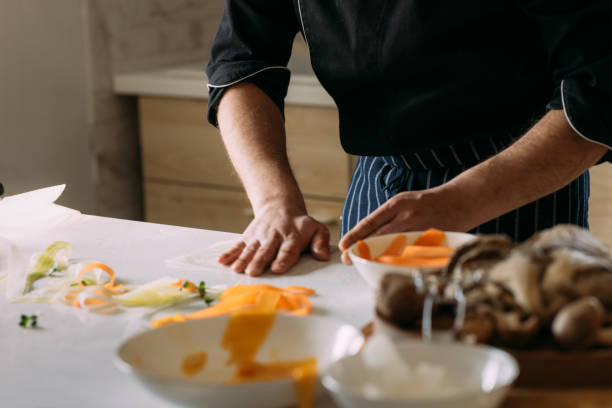 istock Unrecognizable Professional Male Cook Preparing a Tasty Meal 1406723190