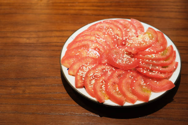 istock Tomato Slices with Sugar.  Sweet cold dish 1406723573