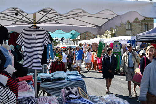 Saint Cast-le-Guildo, Brittany, France, July 4 , 2022 - Unidentified people on the Saint Cast-Le-Guildo weekly market on the Atlantic promenade