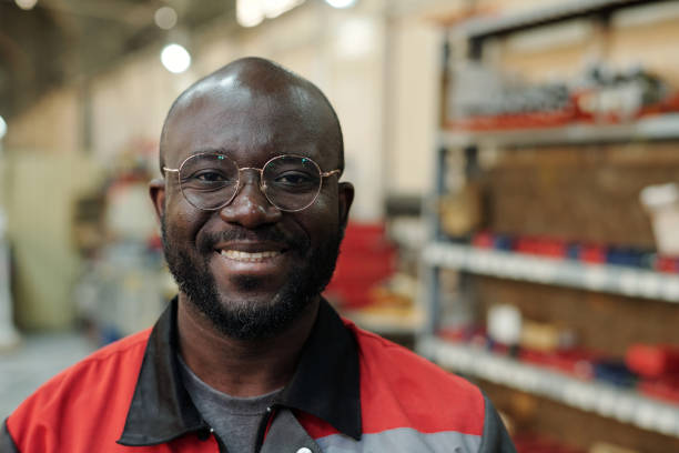 istock Young successful black man in uniform and eyeglasses looking at camera 1406725051