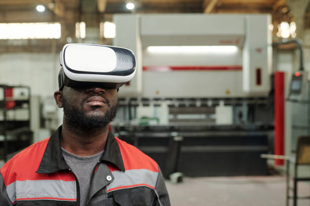 istock Young serious African American male engineer in vr headset making presentation 1406725383