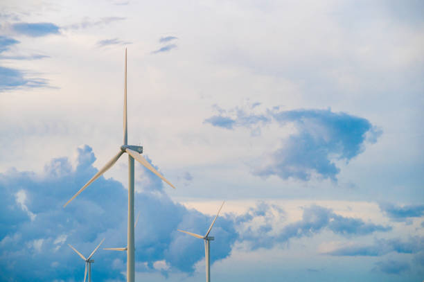 istock Wind turbine generator with blue sky - energy conservation concept. thailand 1406725437