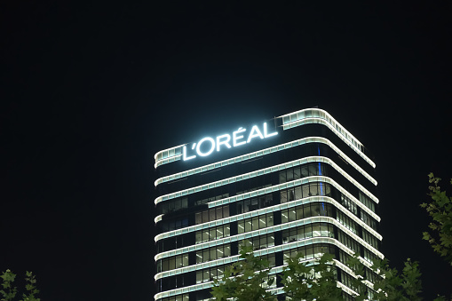 Shanghai,China-July 3rd 2022: L'Oreal company headquarters building and brand logo at night