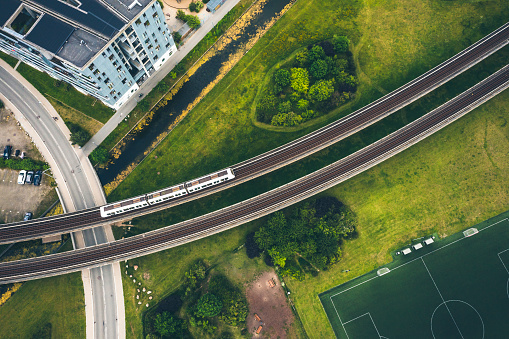 The Copenhagen Metro line  is the popular electricity driven subway that serves as public transportation for commuters underground as well as above as a skytrain. Here it runs across roads and green public park in Islands Brygge close to the city center.