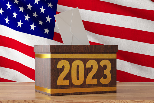 2023 US Electrions Concept with a Wooden Ballot Box and American Flag. 3D Render