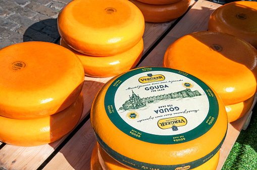 Famous Gouda cheese market in Netherland, with the traditional Dutch cheese , with orange coating, in Gouda, in Southern Netherlands. April 21, 2022